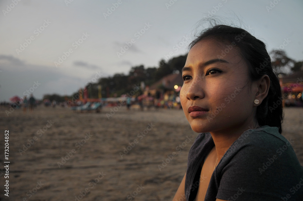 beautiful Asian lonely woman looking to infinity lost in her thoughts sad and thoughtful sitting on sand beach beautiful Asian lonely woman looking to infinity lost in her thoughts sad and thoughtful sitting on sand beach