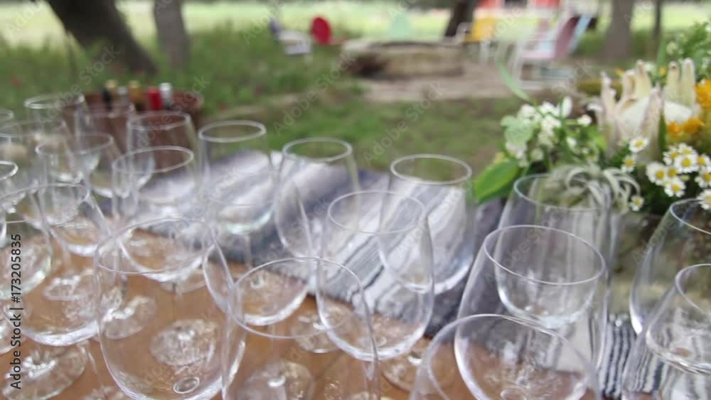 Trucking shot, wine glasses on table outside Trucking shot, wine glasses on table outside