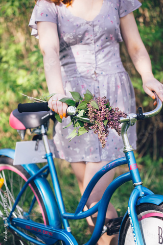 Vitage girl ride on bicycle with flowers