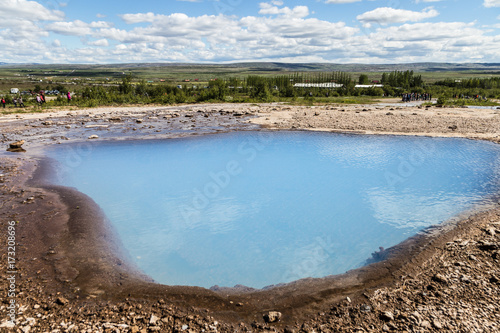 Hot spring in the volcanic landscape around the Strokkur geyser in Iceland, a famous area with many geological features. © jakartatravel