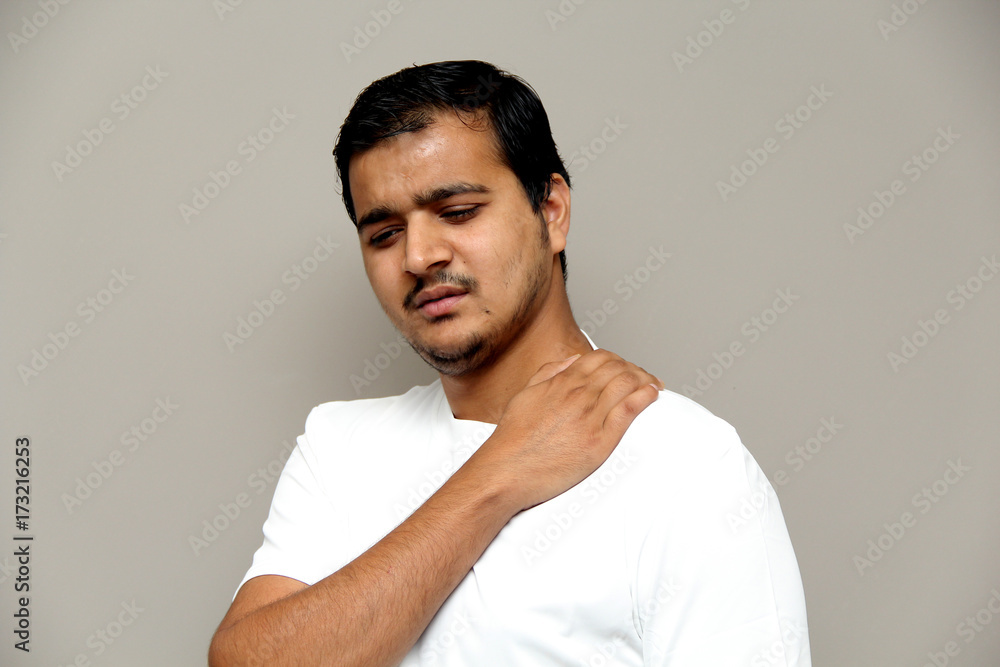 pain in neck, man in pain, expressions of young amazed man isolated on gray background pain in neck, man in pain, expressions of young amazed man isolated on gray background