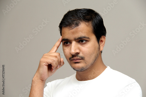 expressions of young amazed man isolated on gray background