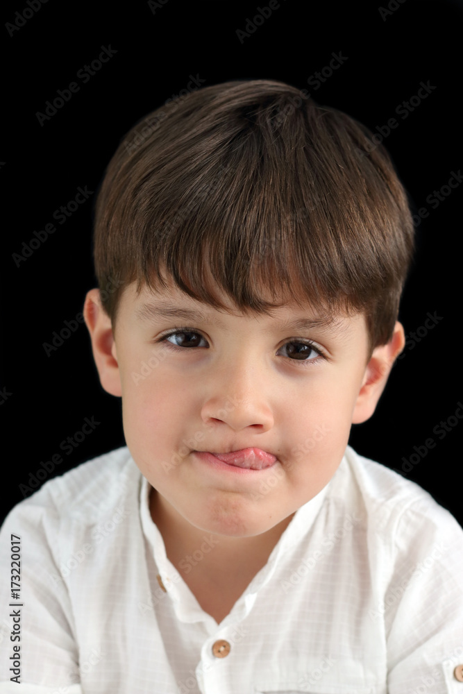 happy child showing the tongue in black background
happy child showing the tongue in black background