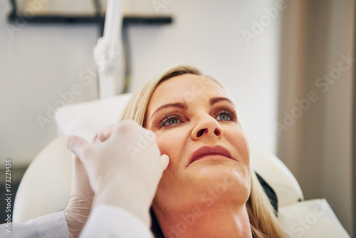 Mature woman getting botox injections at a beauty clinic