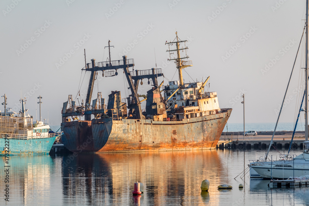 Old rusty shipping boat in the port of vinaros spain