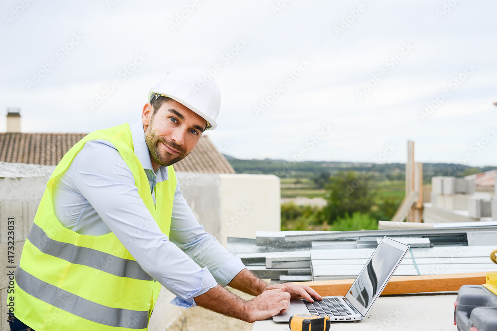 handsome young man foreman architect supervising a new house construction site handsome young man foreman architect supervising a new house construction site