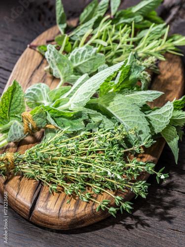 Fresh herbs on the wooden table.