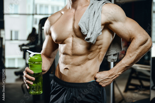 Handsome model young man working out in gym