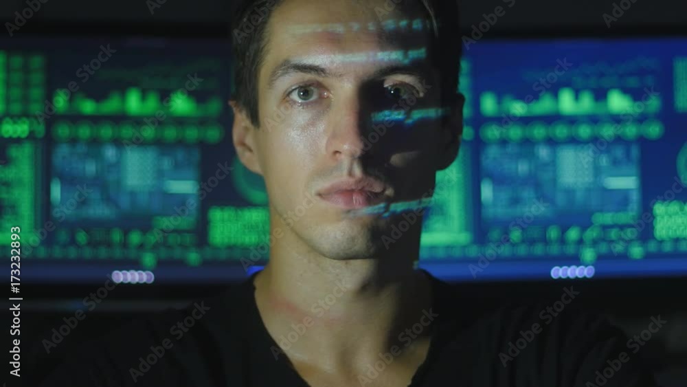 portrait of a young programmer with a binary code on his face in a cyber office portrait of a young programmer with a binary code on his face in a cyber office