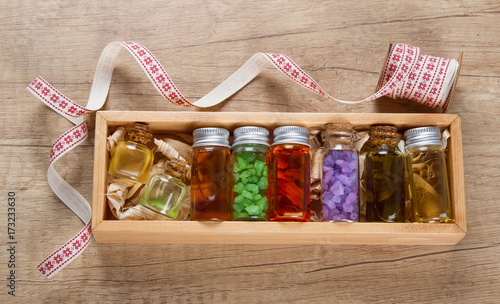 Essential oils and sea salt in wooden gift box photo