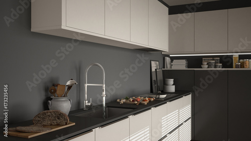 Modern kitchen with sink and stove, cooking pan and food, close-up, white and gray minimalist interior design