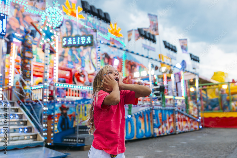 Little girl in the summer amusement park Little girl in the summer amusement park