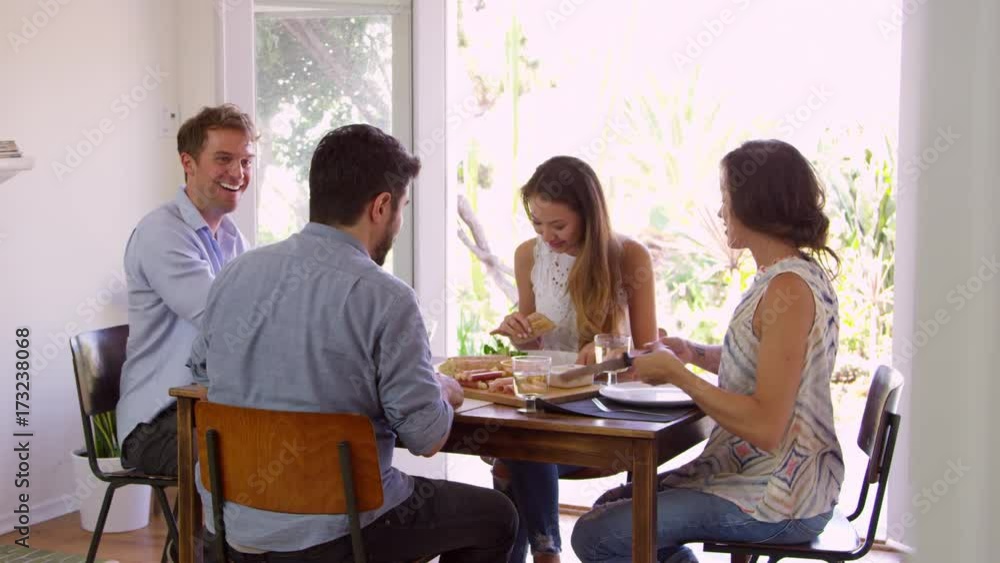 Group Of Friends Enjoying Dinner Party At Home Together Group Of Friends Enjoying Dinner Party At Home Together