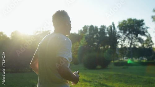 Elderly sporty man jogging in the park