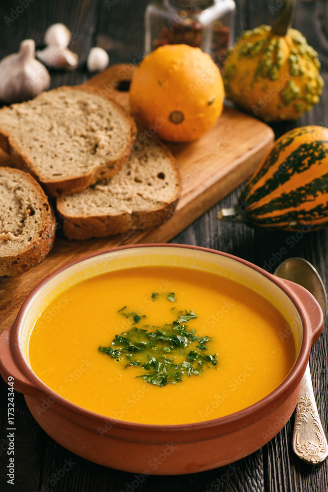Homemade pumpkin cream soup on black background. Homemade pumpkin cream soup on black background.
