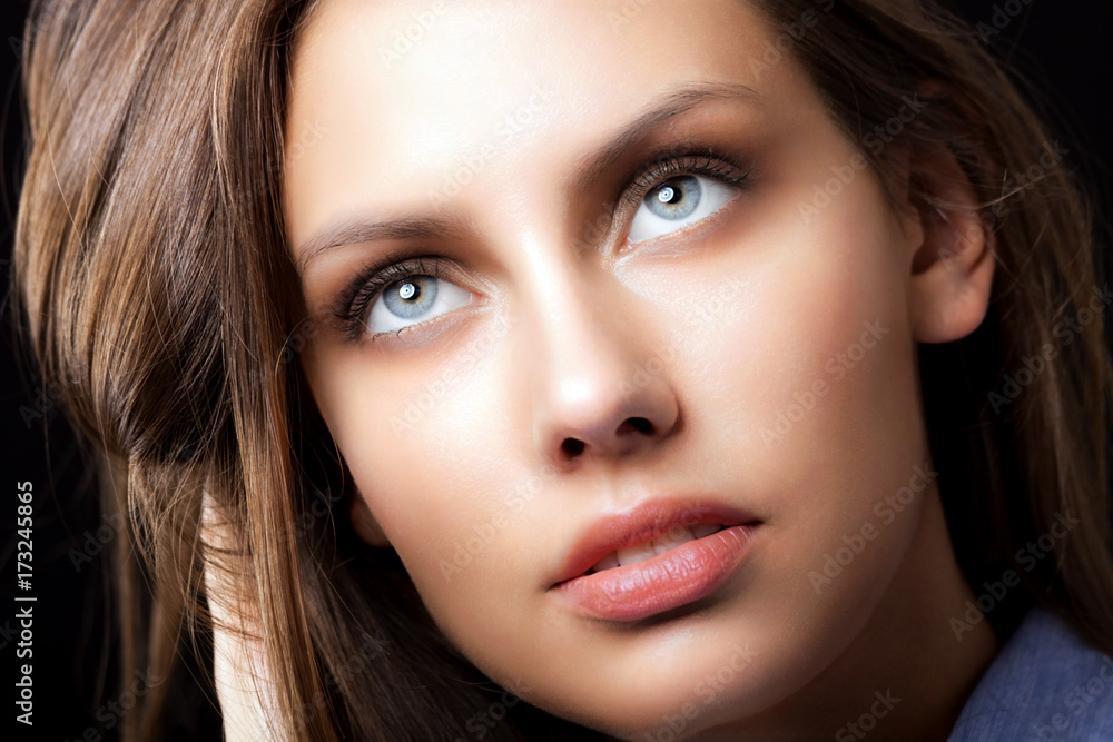 Beautiful young woman portrait holding her hair Beautiful young woman portrait holding her hair