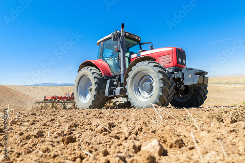 agricultural tractor in the foreground with blue sky background. © David San Segundo