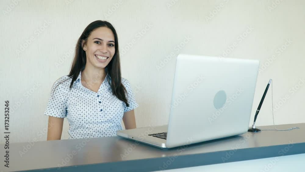 Portrait of a attractive smiling woman at the reception or the hotel company. People stock footage slider shot. Portrait of a attractive smiling woman at the reception or the hotel company. People stock footage slider shot.