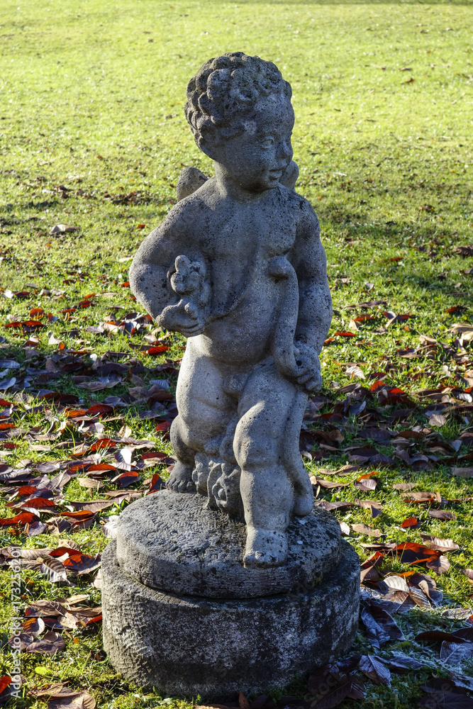 Weathered stone sculpture in a park Weathered stone sculpture in a park