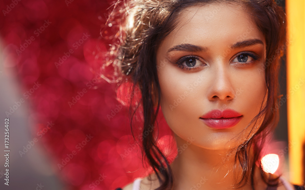 Natural Beauty Woman's Face With Beautiful Hair and Makeup over Colorful Red and Yellow Background. Beautiful Young Teen Girl Natural Beauty Woman's Face With Beautiful Hair and Makeup over Colorful Red and Yellow Background. Beautiful Young Teen Girl