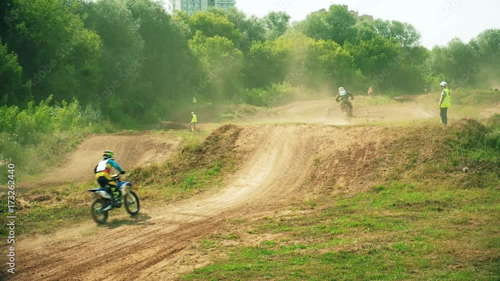 Racing on motorcycles, jumping on a dusty road Racing on motorcycles, jumping on a dusty road