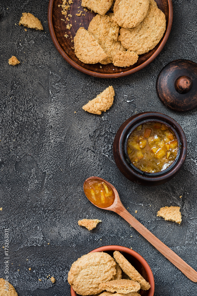 Cookies and orange jam on dark background, copy space. Dessert concept