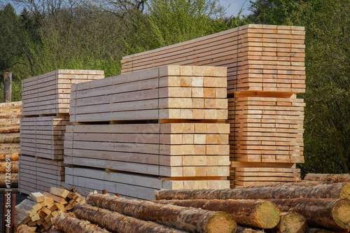 Holzwirtschaft - Sägewerk, Bauholzstapel zwischen Rundholzhaufen photo