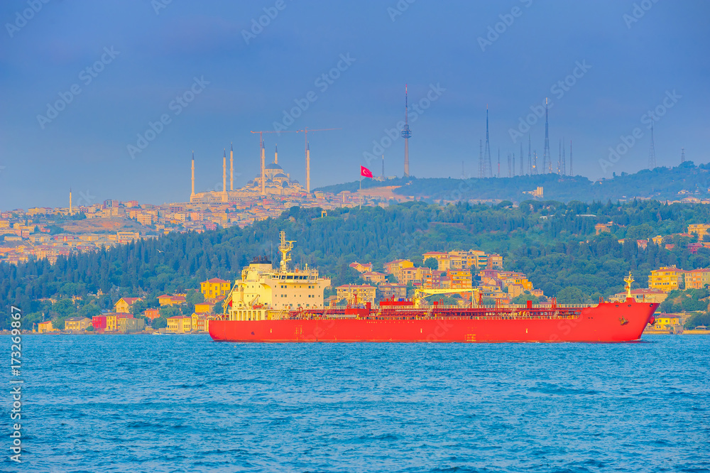 big ship passes through the Bosphorus strait, on a sunset, Istanbul