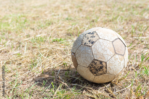 Old soccer ball, forgotten in the grass © chalermchai