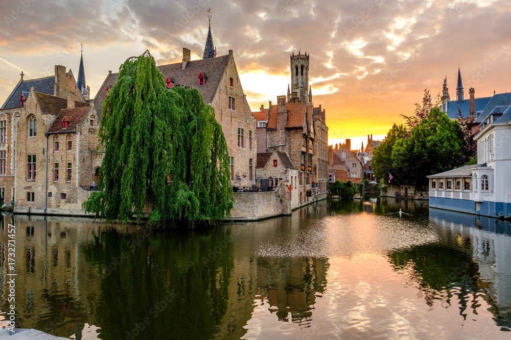 Bruges (Brugge) cityscape with water canal at sunset