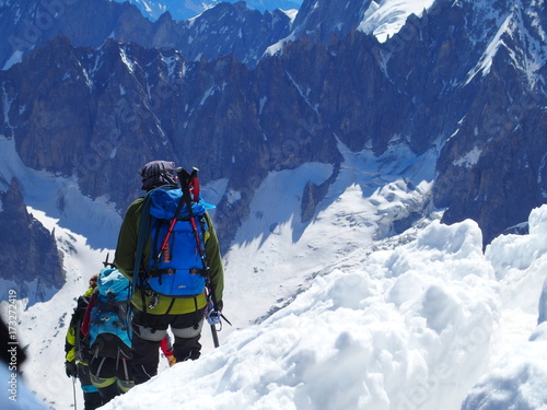 Two alpinists and mountaineer climber on Aiguille du Midi