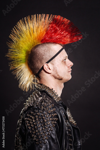 Quadro su tela Portrait of punk rocker with Mohawk on a black background.