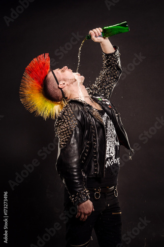 Quadro su tela Portrait of punk rocker with Mohawk on a black background.