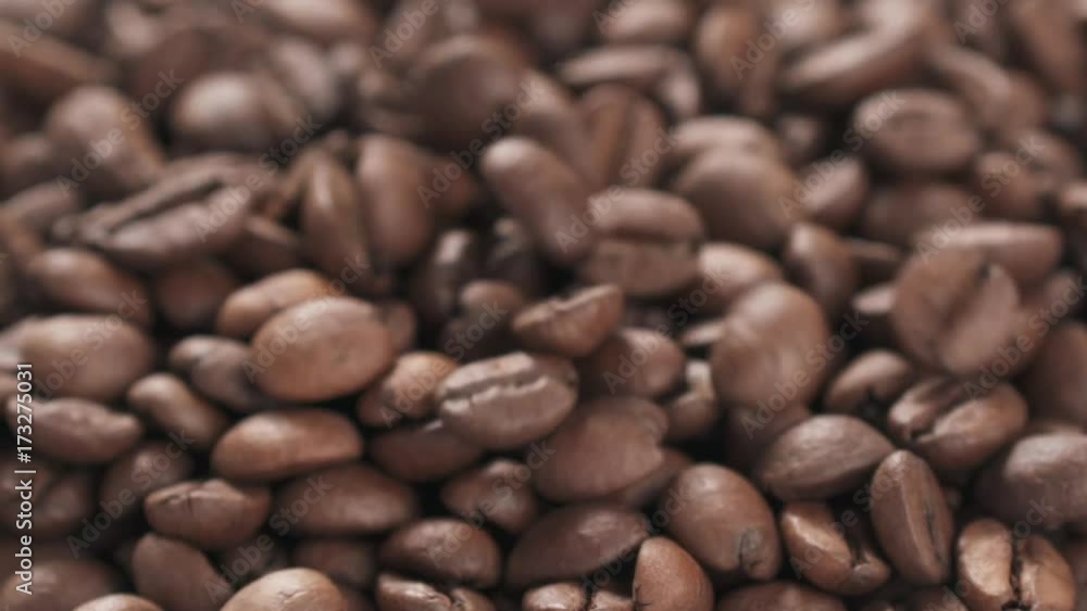 Slow motion closeup coffee beans falling into bowl Slow motion closeup coffee beans falling into bowl