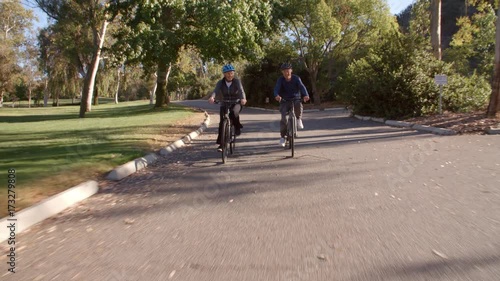 Wallpaper Mural Senior Couple Cycling Through Park In Slow Motion Torontodigital.ca
