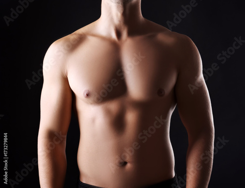 Sporty young man on dark background