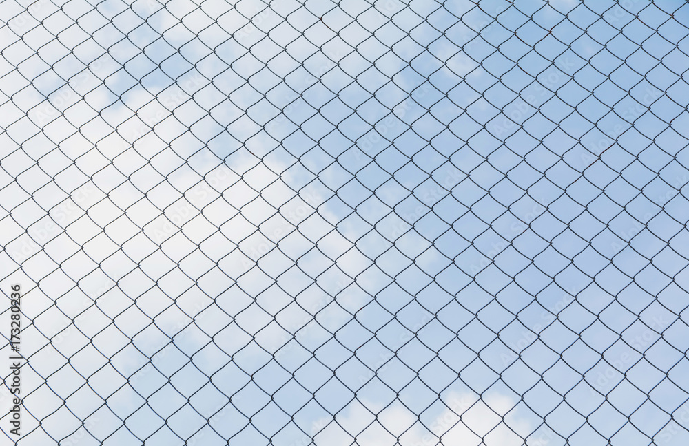 Rusty chain link fence under the sky background. Abstract closeup of a chain link sky background. Rusty chain link fence under the sky background. Abstract closeup of a chain link sky background.