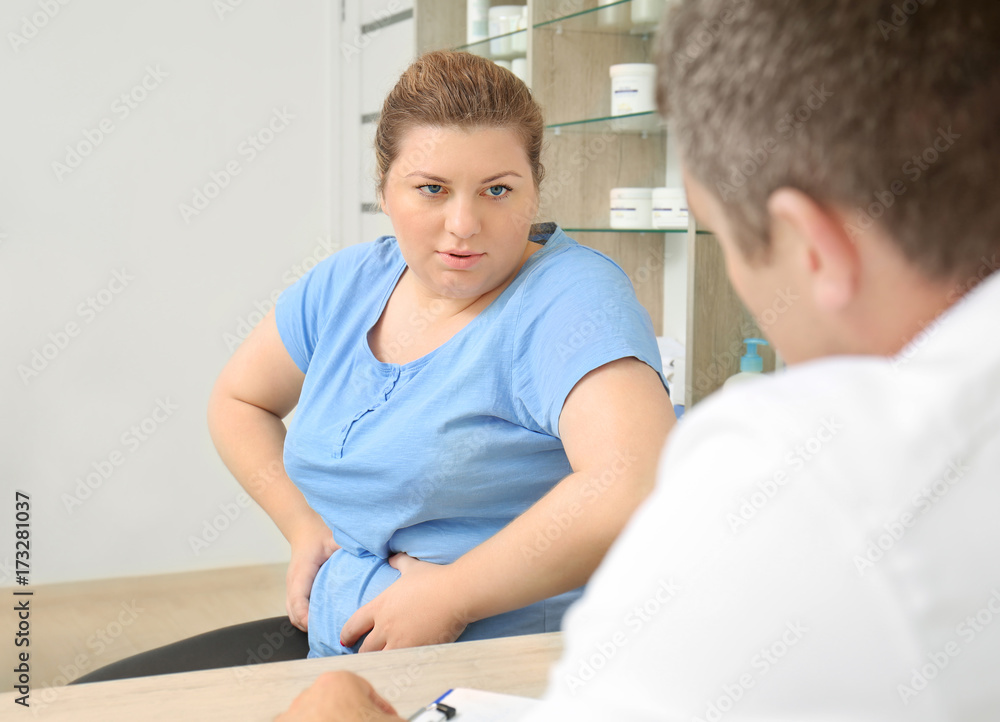 Fototapeta premium Overweight woman having consultation at doctor's office