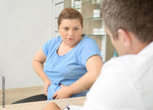 Overweight woman having consultation at doctor's office