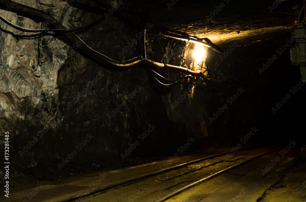 Naklejka premium Underground mining tunnel with rails