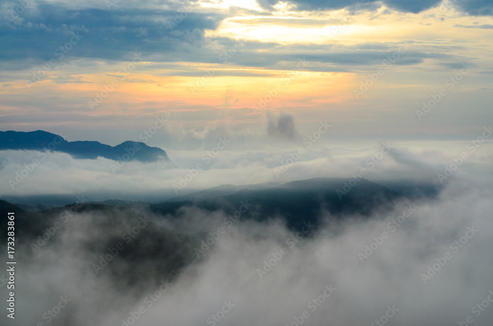 Fog and cloud in mountain valley landscape