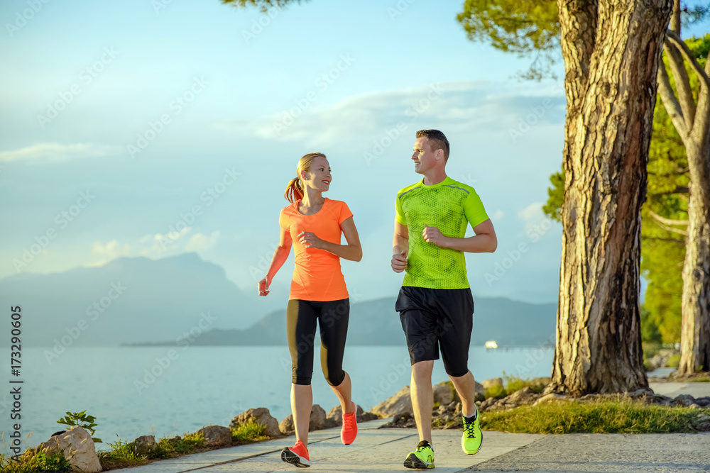 Young sexy couple is running along the promenade. they are doing