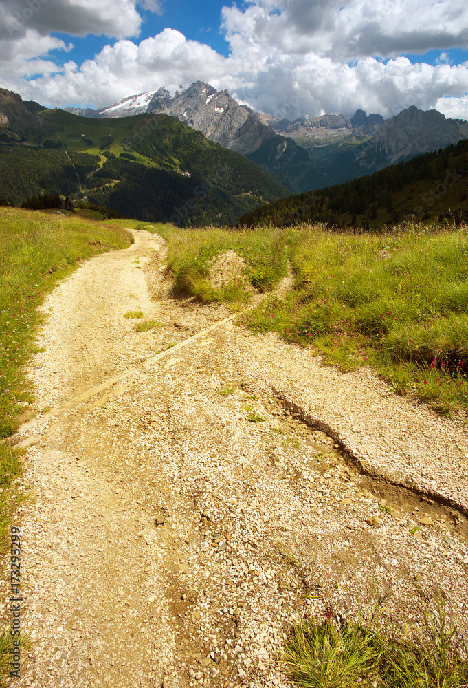 Way in Dolomites with Marmolada peak on the background, Italy