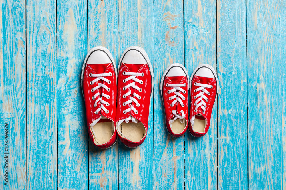 red sneakers on wooden background.