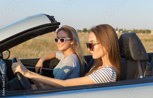 Two attractive young women in a cabriolet car © fotofabrika