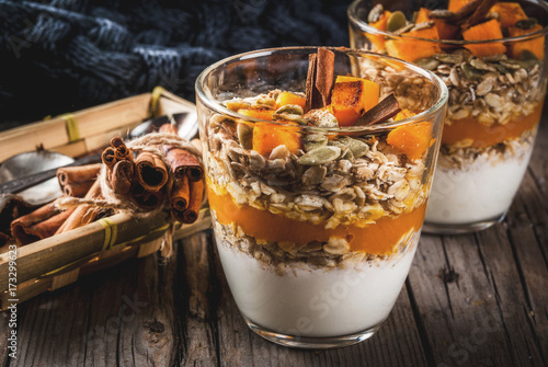 Photos Traditional autumn dishes, spicy pumpkin pie overnight oatmeal with cinnamon, anise and maple syrup