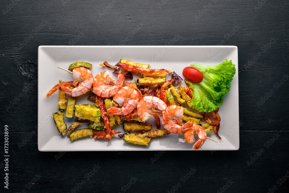 Roasted Royal Prawns with Grilled Vegetables. On a wooden background. Top view. Free space. Roasted Royal Prawns with Grilled Vegetables. On a wooden background. Top view. Free space.