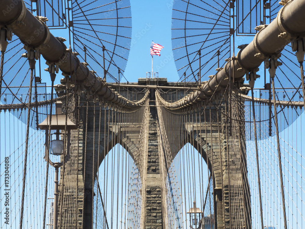 Fototapeta premium Brooklyn Bridge Tower with USA flag - Brooklyn, New York, NY, United States of America, USA