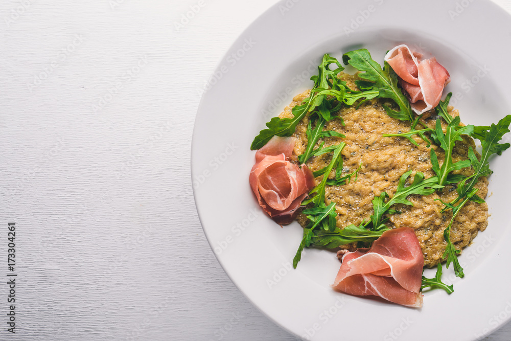 Risotto with diced meat and arugula. Top view. Free space. Risotto with diced meat and arugula. Top view. Free space.