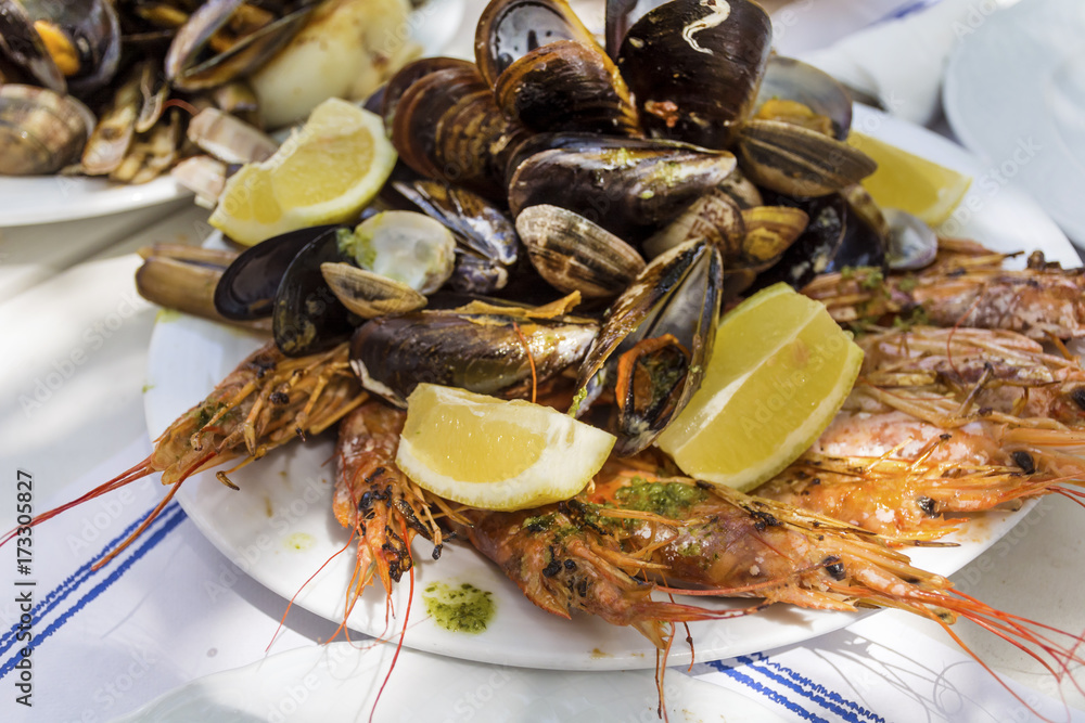 mix of spicy shrimps and shellfish cooked with parsley, garlic and lemon mix of spicy shrimps and shellfish cooked with parsley, garlic and lemon